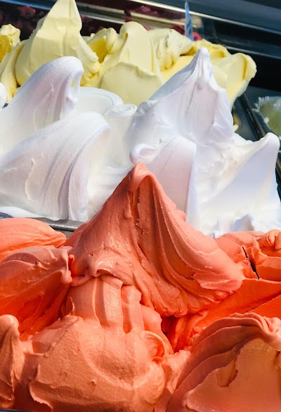 Multiple scoops of artisan gelato in vivid coral and cream tones displayed at Favourite Flavours, Bendigo