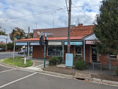 Exterior of Favourite Flavours at 253 Napier St Bendigo, showing the branded "flavours" sign in mint-teal on a brick building