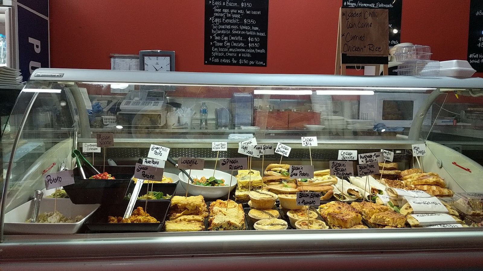 The deli cabinet full of pies, quiches and slices