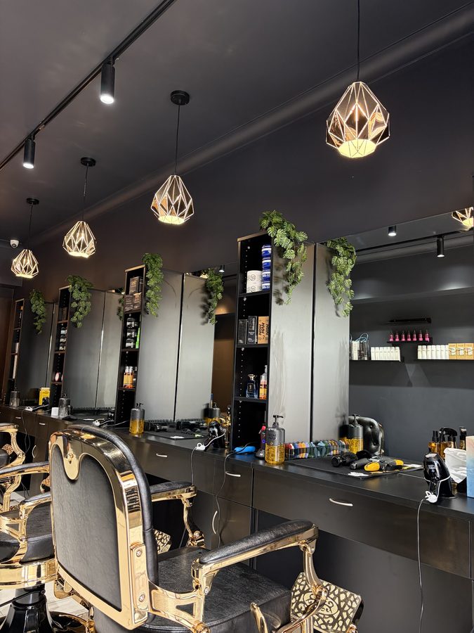 Vip Barber Orange styling station with mirrors, products and a gold barber chair