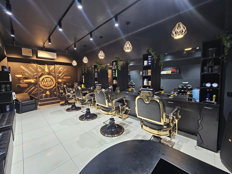 Inside Vip Barber Orange — gold-framed barber chairs and styling floor