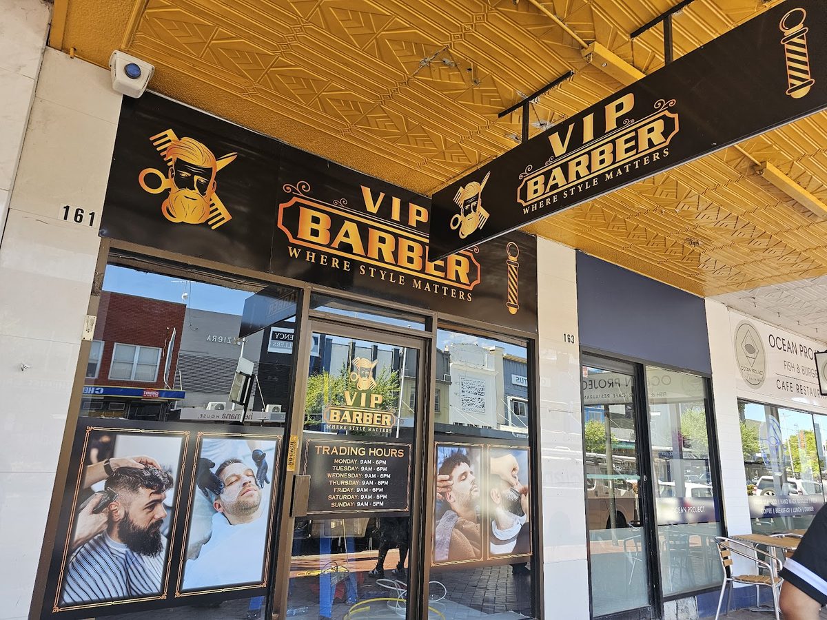 Vip Barber Orange storefront and illuminated signage on Summer St