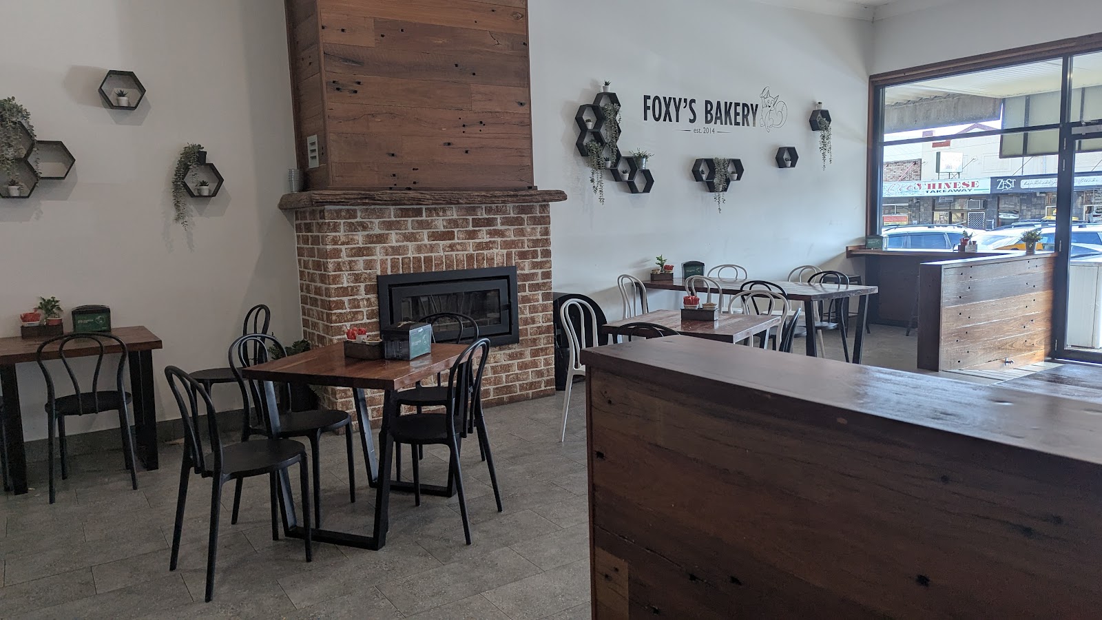 Wide view of Foxy's Bakery dining room with the Foxy's Bakery wall sign