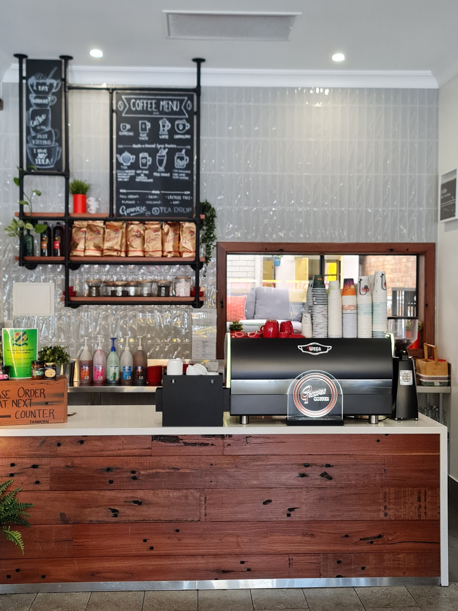 Coffee counter with espresso machine, chalkboard coffee menu and retail coffee beans