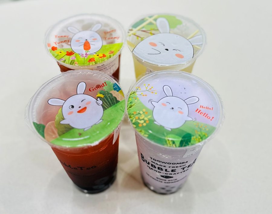 Four Bubble Tea City drinks with rabbit-lid branding, fruit teas and milk teas