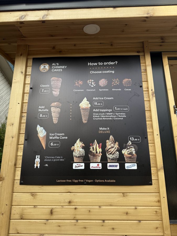 AL's Chimney Cakes printed menu board with prices and flavours