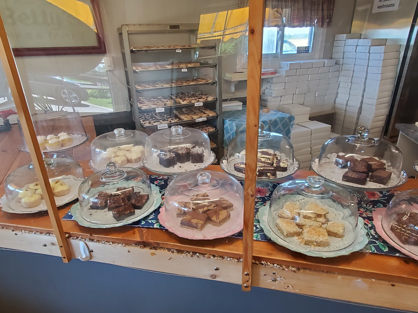 Wide view of the bakery display cases and baking racks inside Betty's