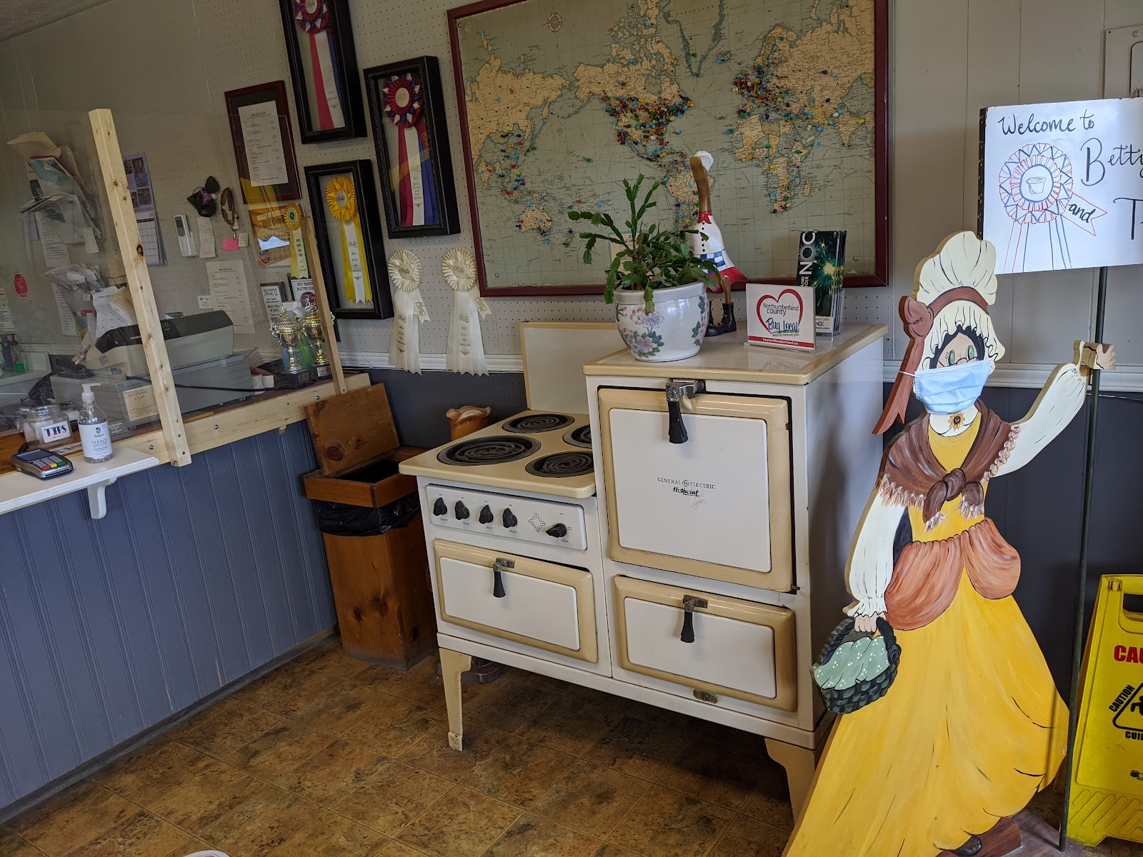 Heritage corner with a vintage stove, award ribbons on the wall and the painted mascot