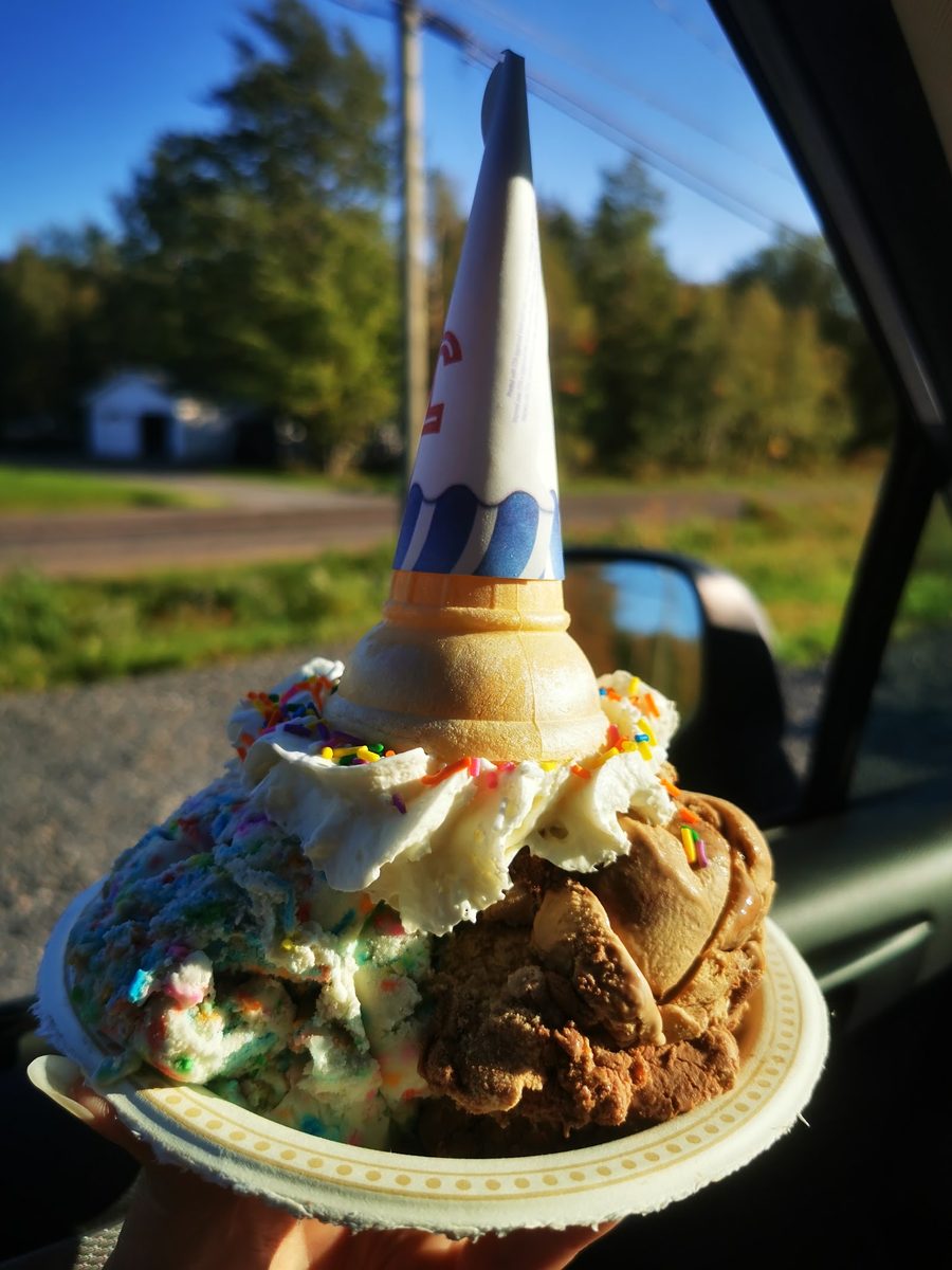 A generous KT's Tasty Treats sundae with whipped cream and topping