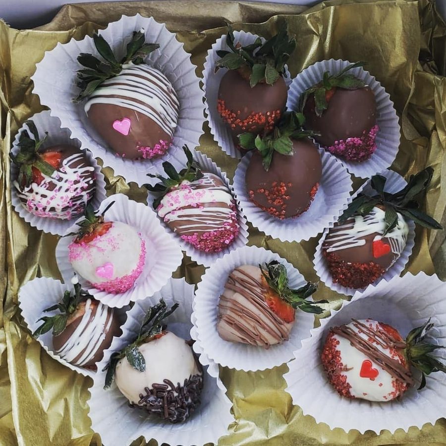 Chocolate-covered strawberries in a gold gift box