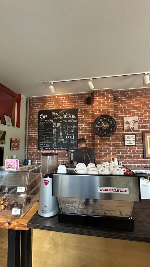 The café counter and chalkboard menu with the La Marzocco espresso machine