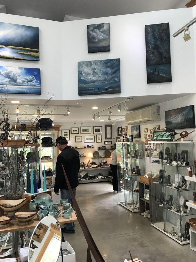 Original Maritime seascape paintings hung above glass jewellery cases
