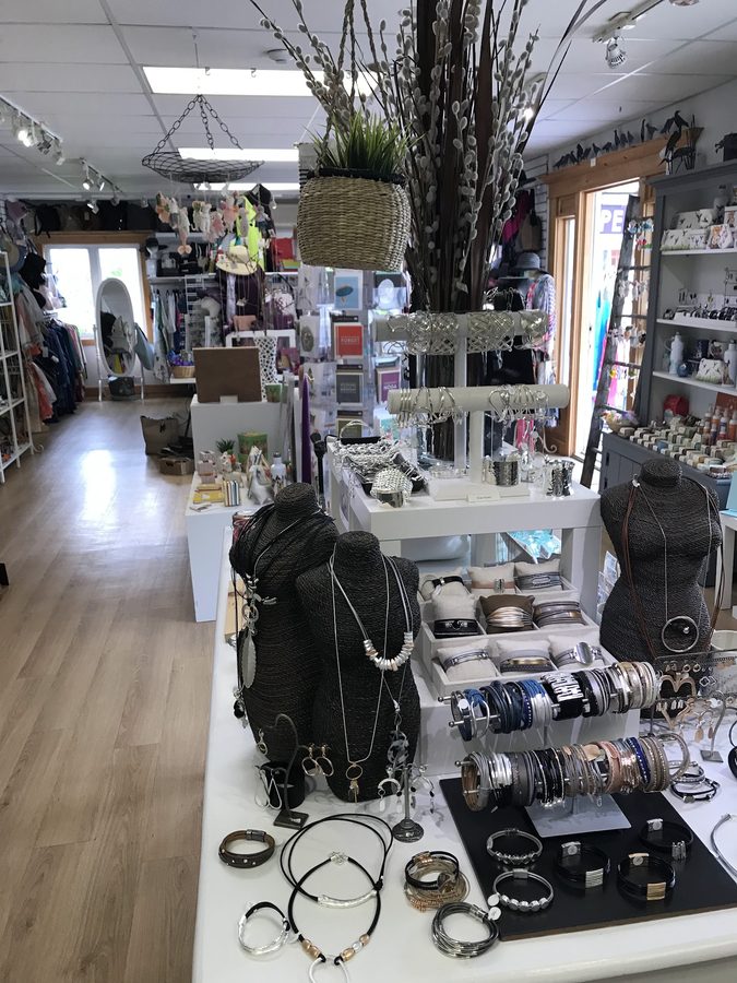 Handmade jewellery in a lit display case at Northern Sun Gallery & Gifts