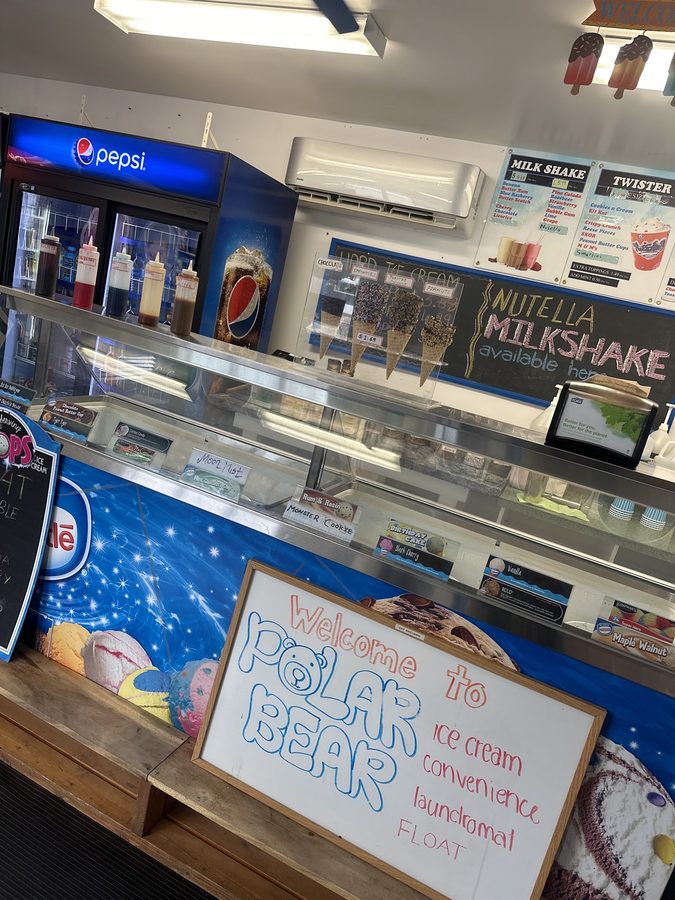 The counter case and hand-painted "Welcome to Polar Bear" sign