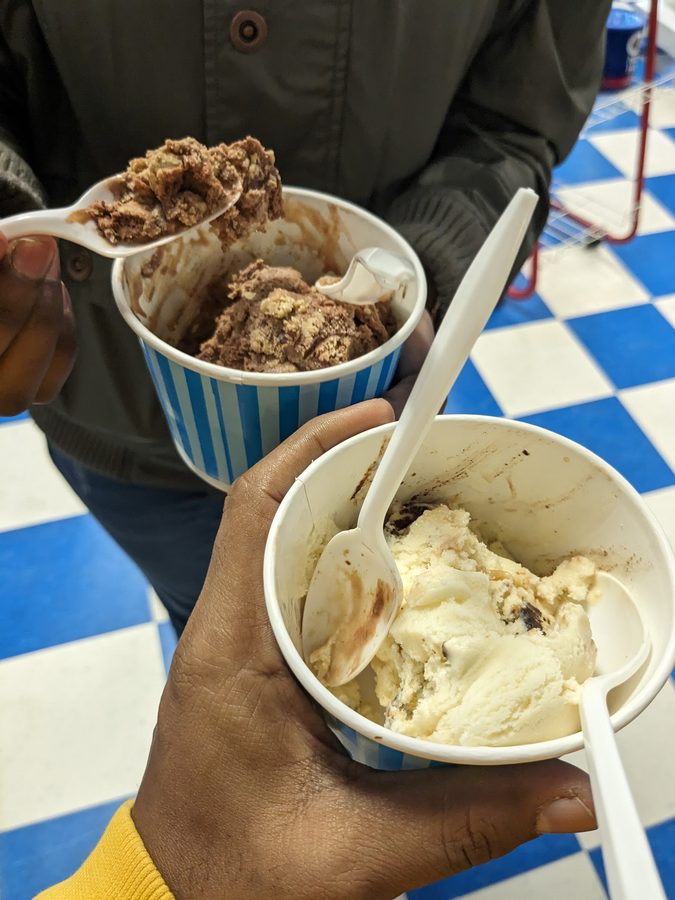 Two customers holding ice cream cups served at Polar Bear Ice Cream