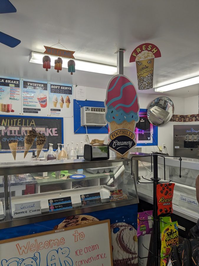 The counter and menu boards inside Polar Bear Ice Cream showing soft serve, milkshakes and twisters