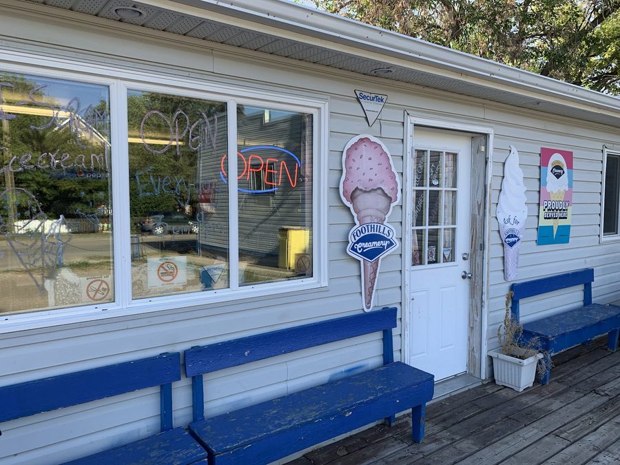 Polar Bear Ice Cream's walk-up storefront on 4th Ave NW with OPEN signage and Foothills Creamery cone decals