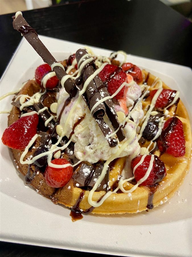 The Chill Desire's signature round Belgian waffle topped with ice cream, chocolate curls, strawberries and chocolate drizzle