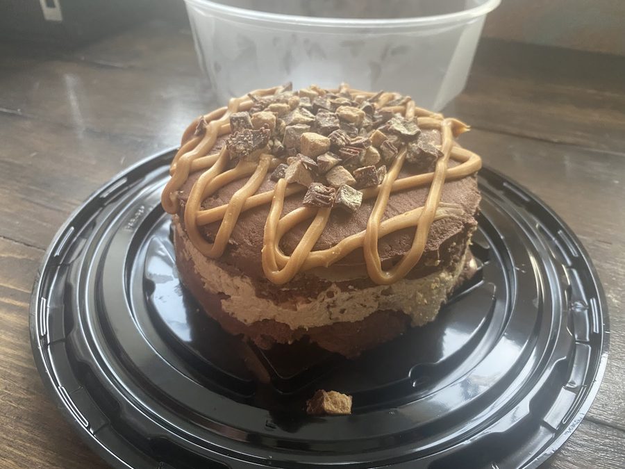 A chocolate peanut butter cup ice cream cake with caramel drizzle
