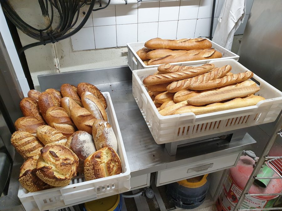 Crates of freshly baked baguettes ready for the shop floor