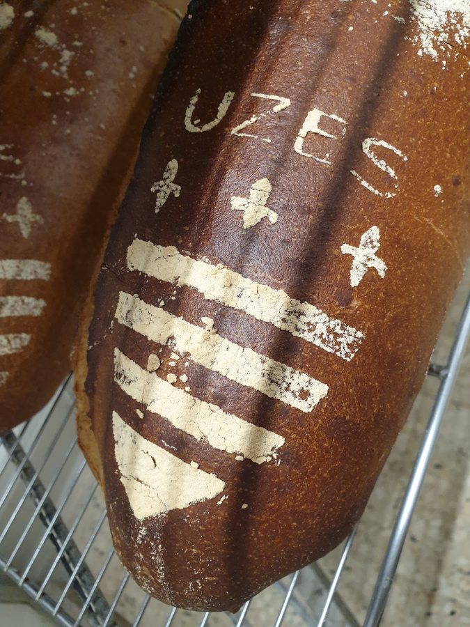 Fougasse loaf with UZES stenciled into the crust