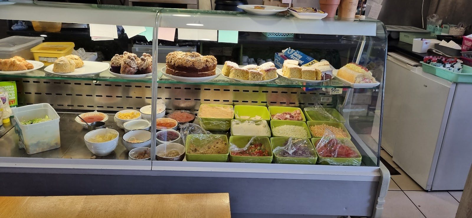 The display case of homemade cakes, scones and fresh fillings at Goodies