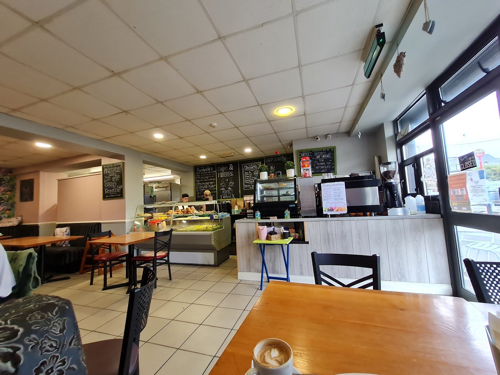 The warm interior of Goodies Coffee House with counter and tables