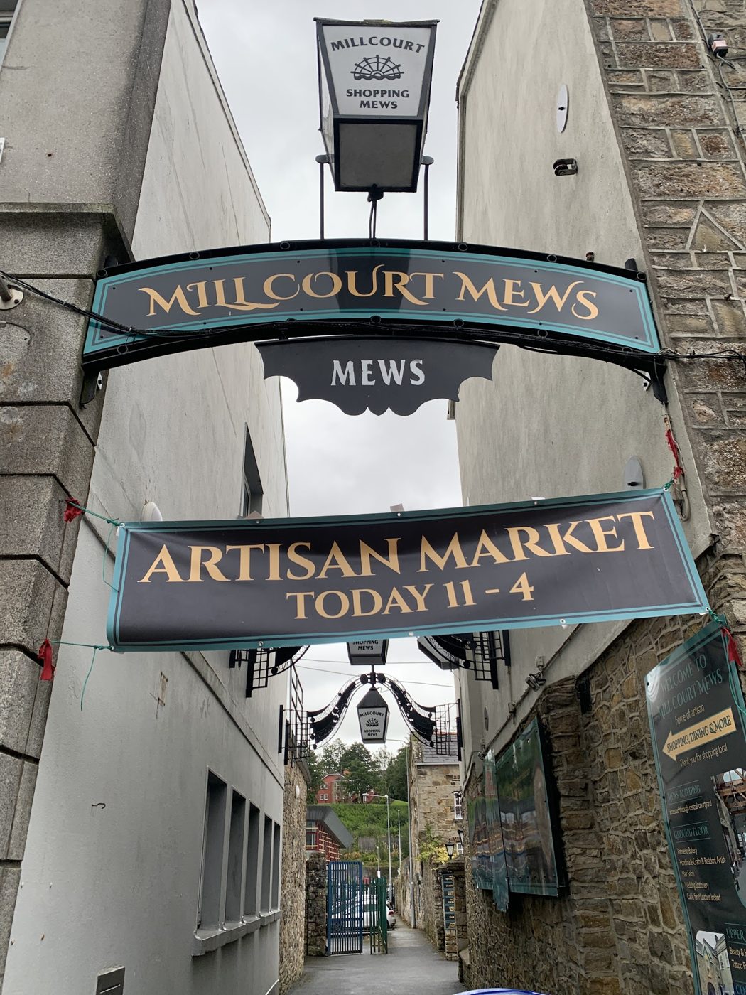 Millcourt Mews laneway signage with an artisan market banner