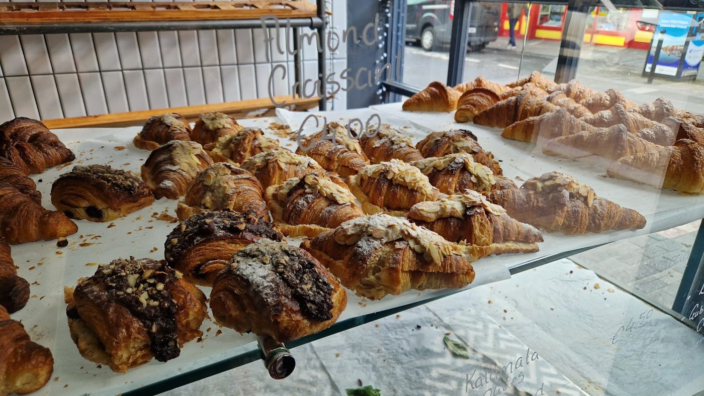 Almond croissants and pain au chocolat in the display case