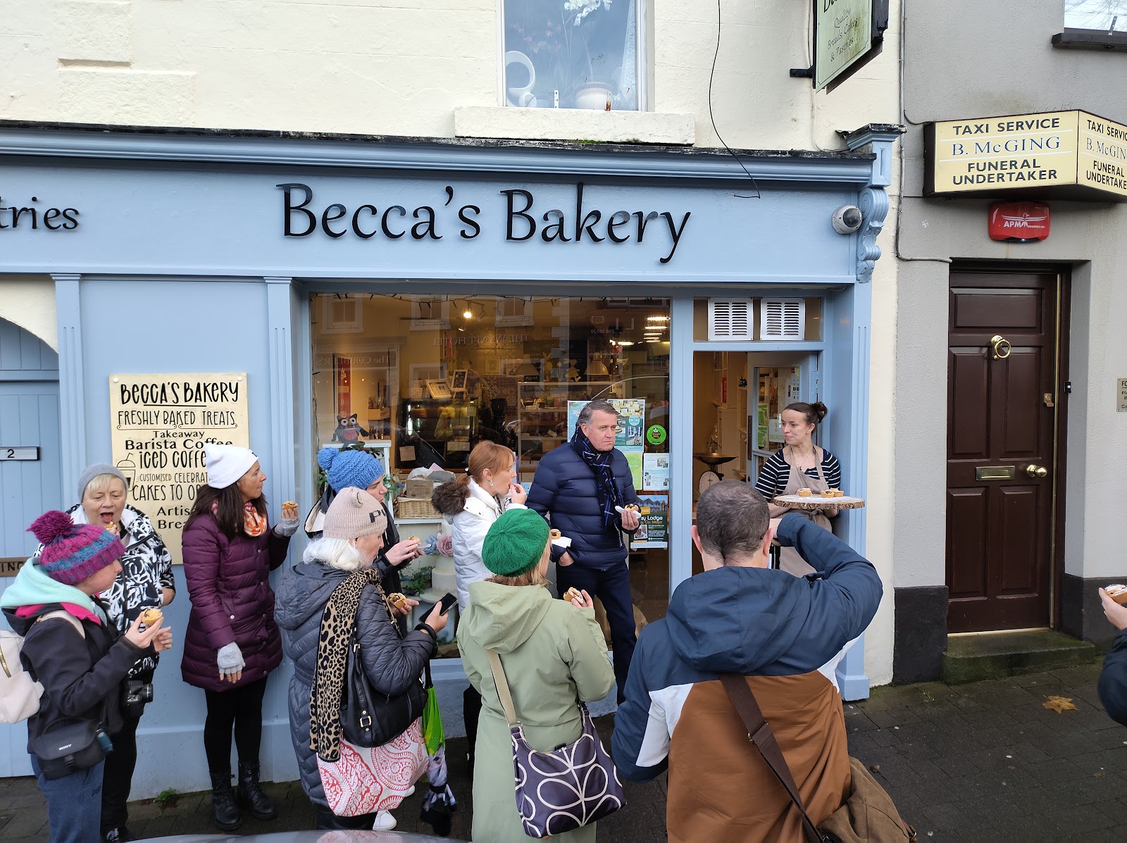 Customers gathered outside Becca's Bakery being served fresh treats on The Octagon, Westport