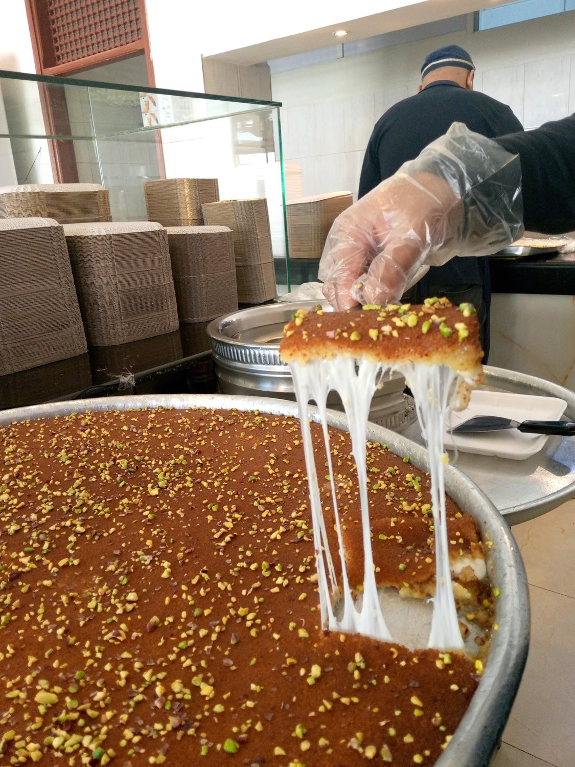 Kunafa being prepared / تحضير الكنافة