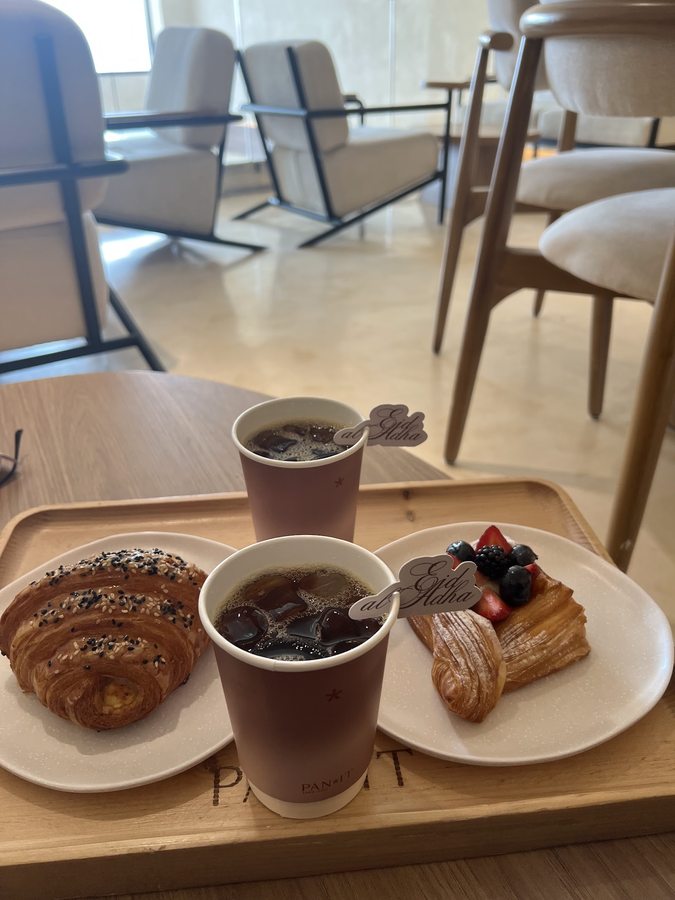 PAN*IT branded cup with a coconut croissant