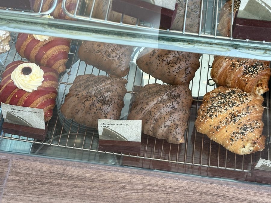 PAN*IT in-store display case with item names and prices