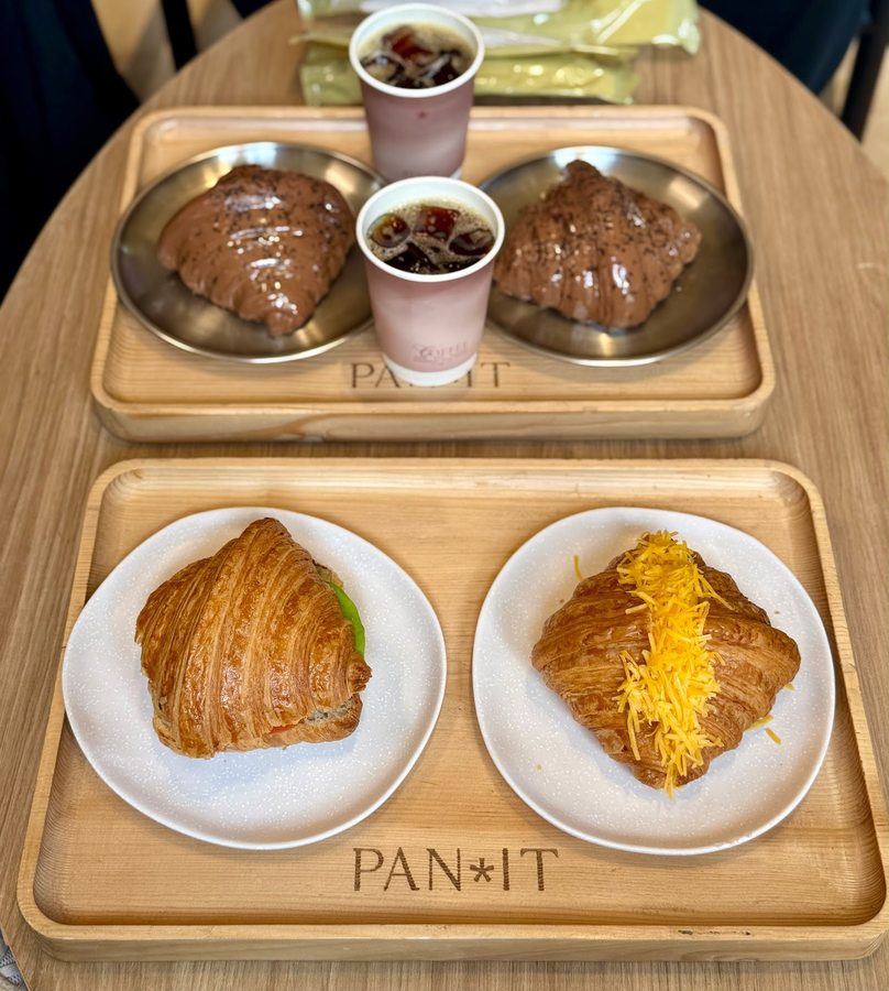 Tray of croissants and coffee on a PAN*IT branded wooden tray