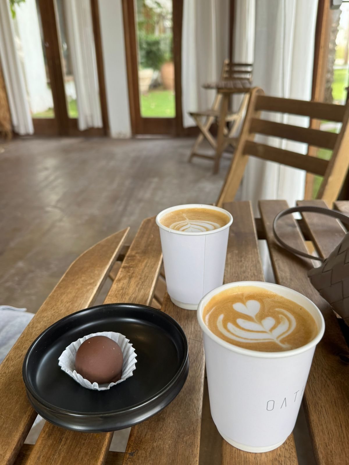 Two matcha and coffee drinks on a wooden table