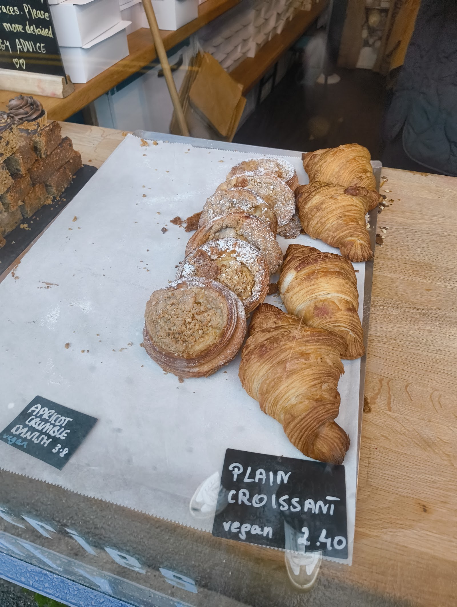 Display-case tray at The Tiny Bakery with handwritten price cards