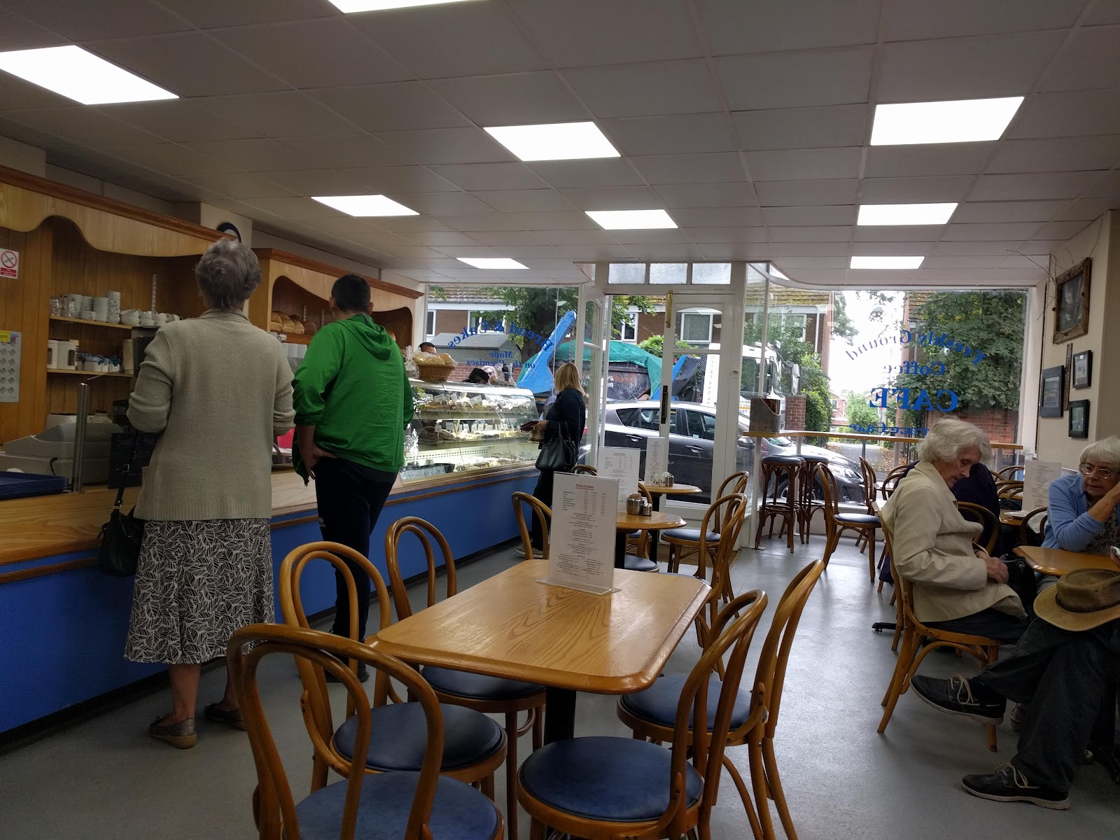 The bright, cosy café room at Mr Bun The Baker with bentwood chairs and customers