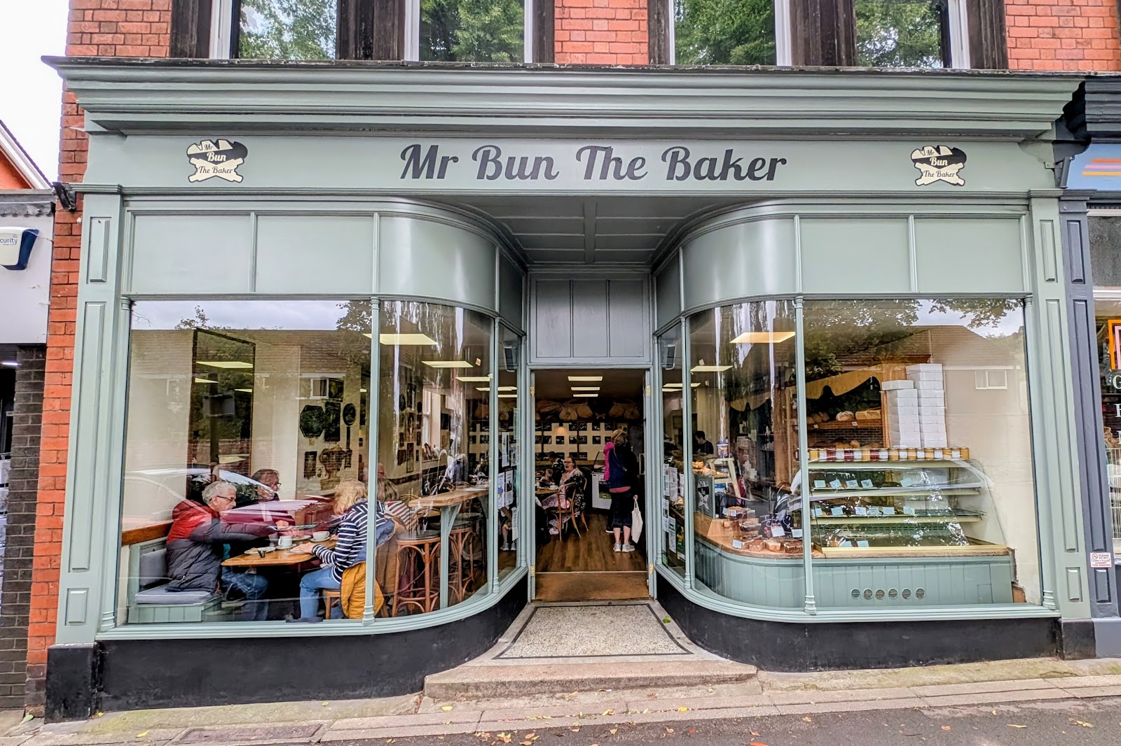 The sage-green shopfront of Mr Bun The Baker on Sandford Avenue, Church Stretton