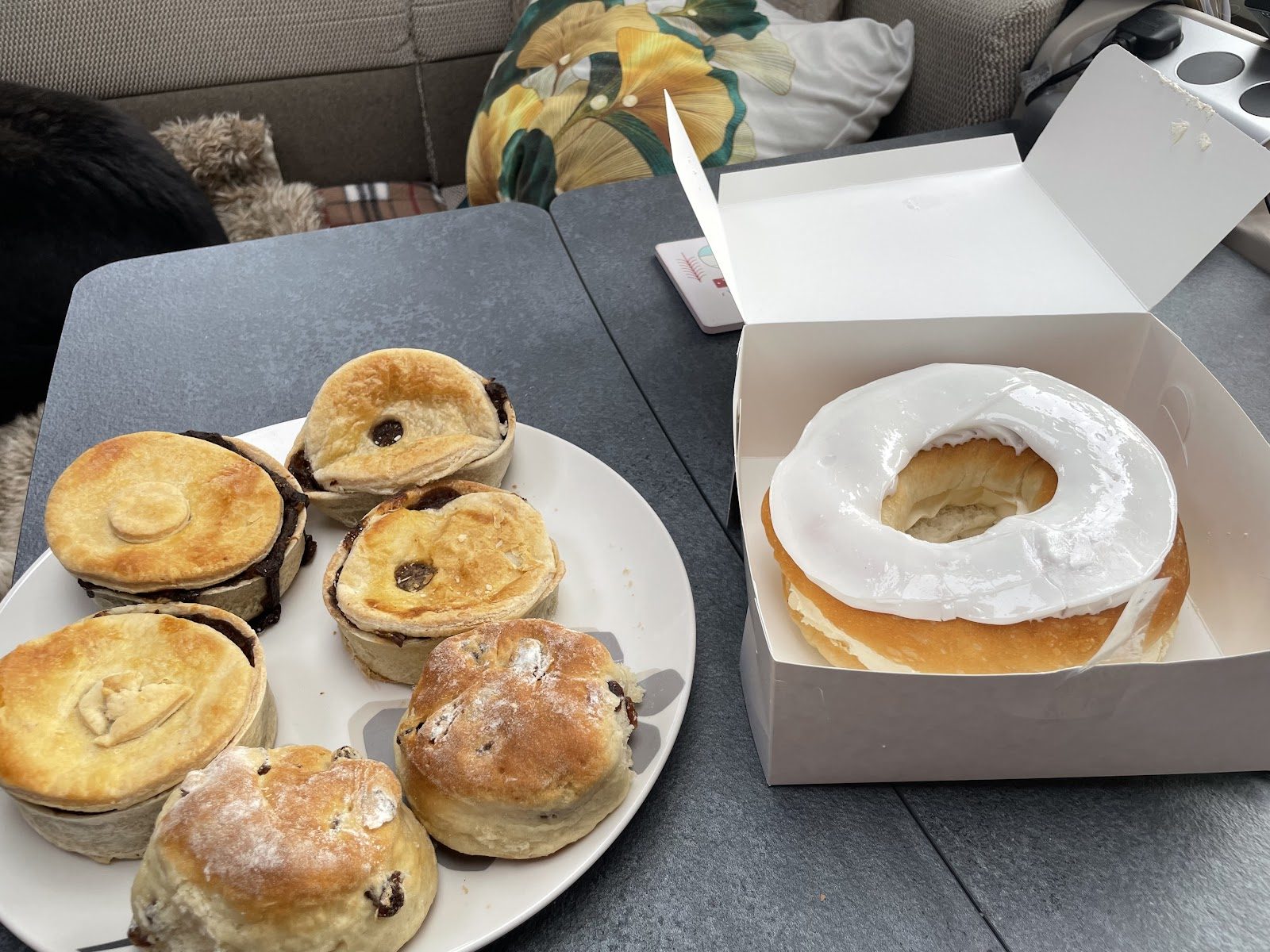 A spread of Paul Jones Bakery savoury pies, fruit scones and an iced cream doughnut