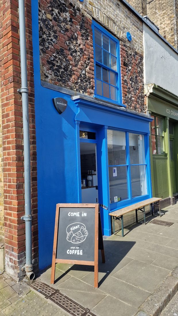 The cobalt-blue GIANT COFFEE shopfront with an A-board reading 'Come in, open for coffee'.