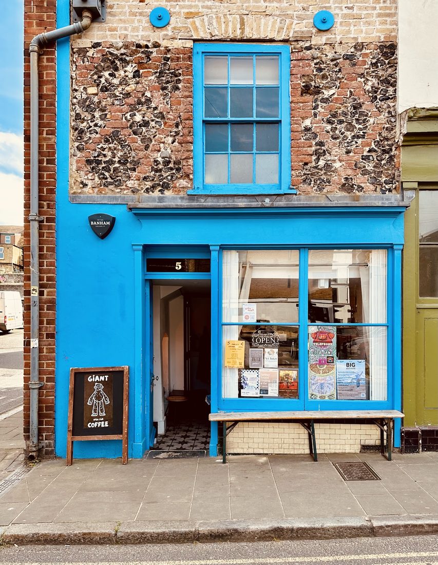 The bright blue GIANT COFFEE shopfront at 5 Market Street, Margate, with its door open.