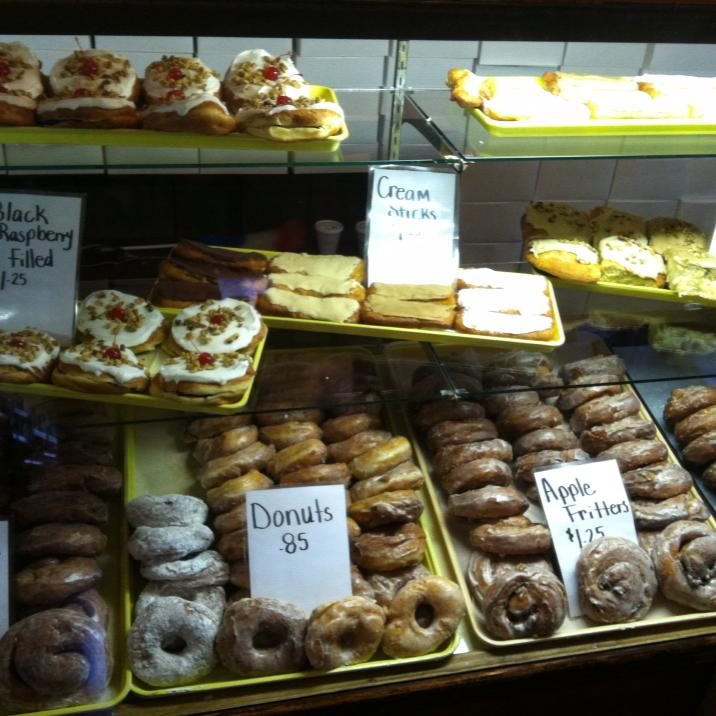 Miller's Bakery display case full of glazed donuts, cream sticks, apple fritters and filled pastries