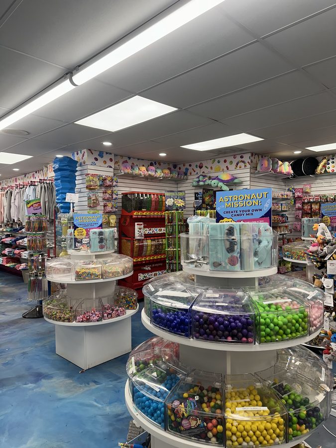Tiered bins of colorful gumballs and candy for a create-your-own mix