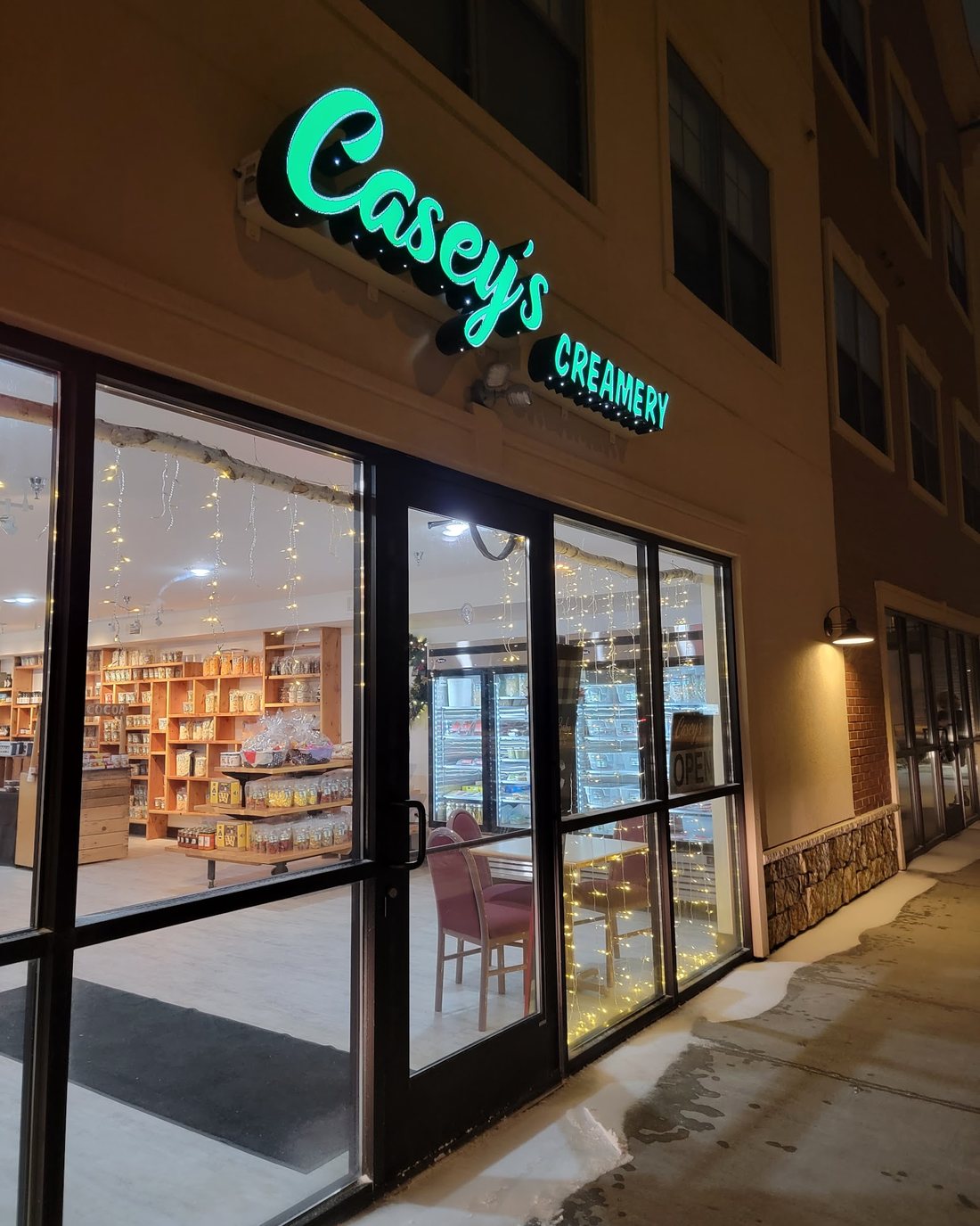 Casey's Creamery storefront sign lit up in the evening