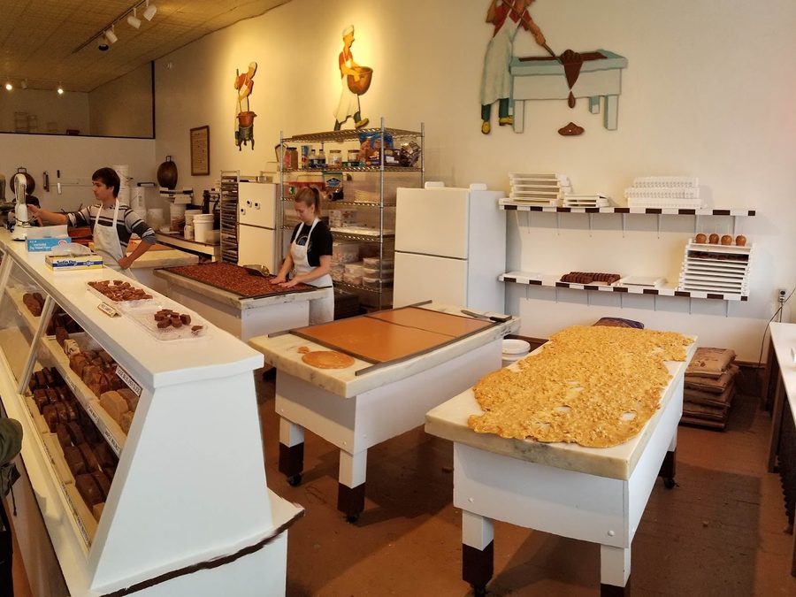 Caramel and brittle being worked by hand on a marble slab