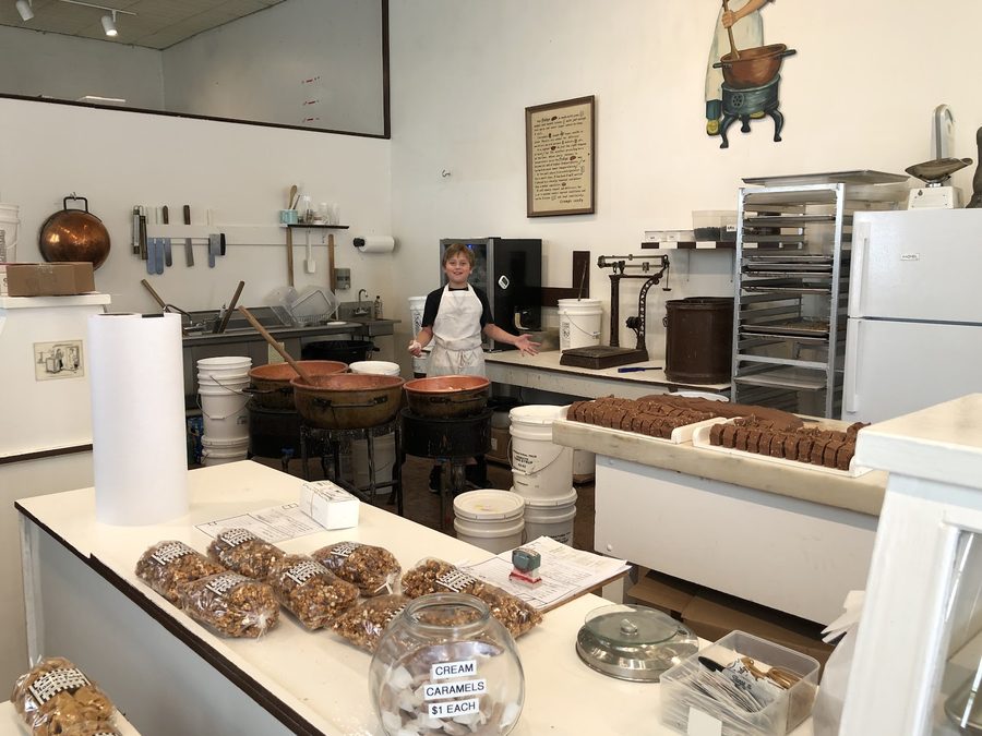 Copper kettles and marble tables in the Howse's Fudge shop, with a fresh chocolate fudge loaf