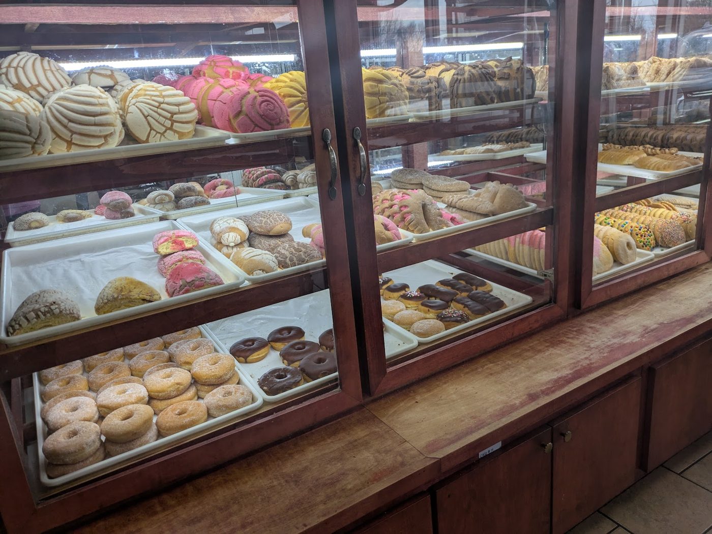 Case full of conchas, pan dulce and donuts at Celia's Bakery