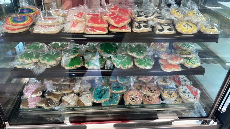 Display case of decorated sugar cookies in many colors and designs