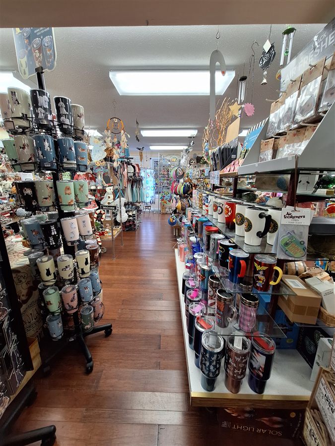 Racks of novelty mugs and tumblers inside the shop