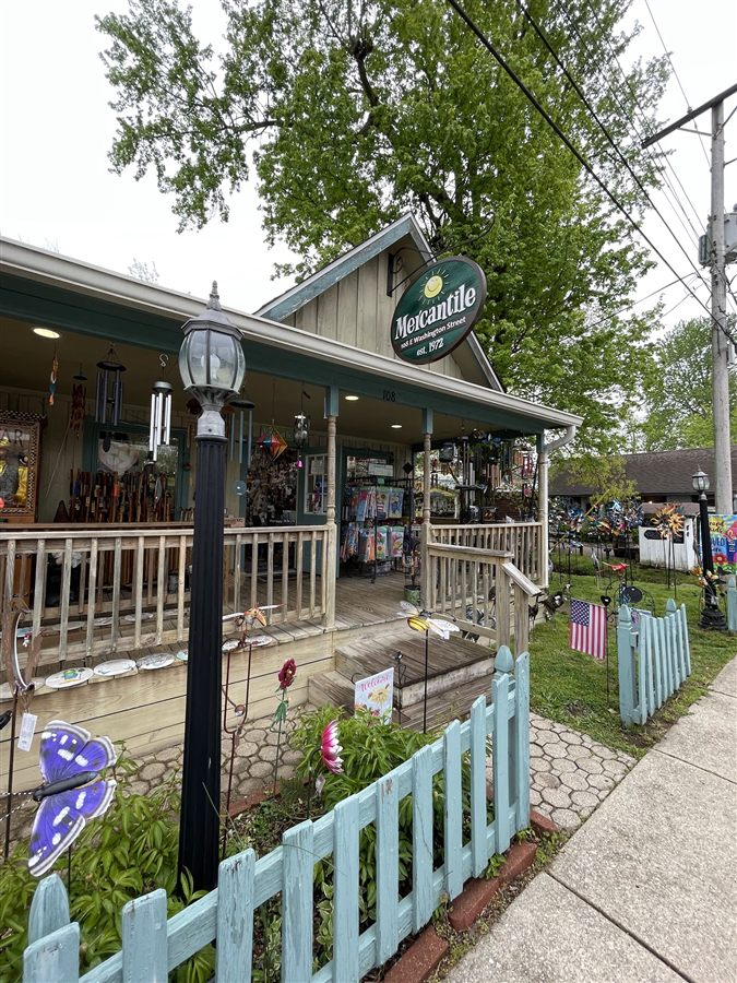 The storefront of The Nashville Mercantile Store with its oval hanging sign and covered porch
